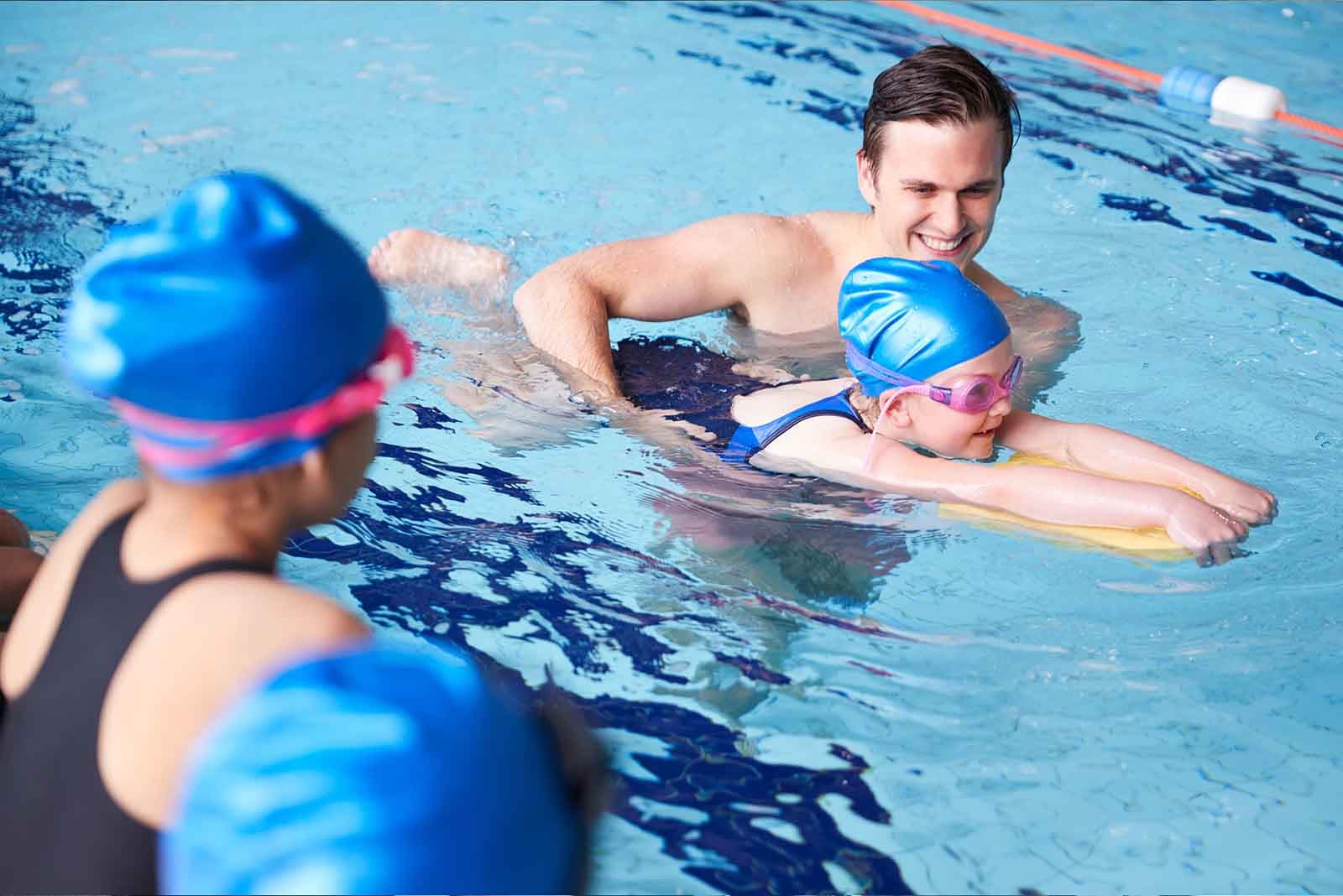 A swimmer diving into the pool