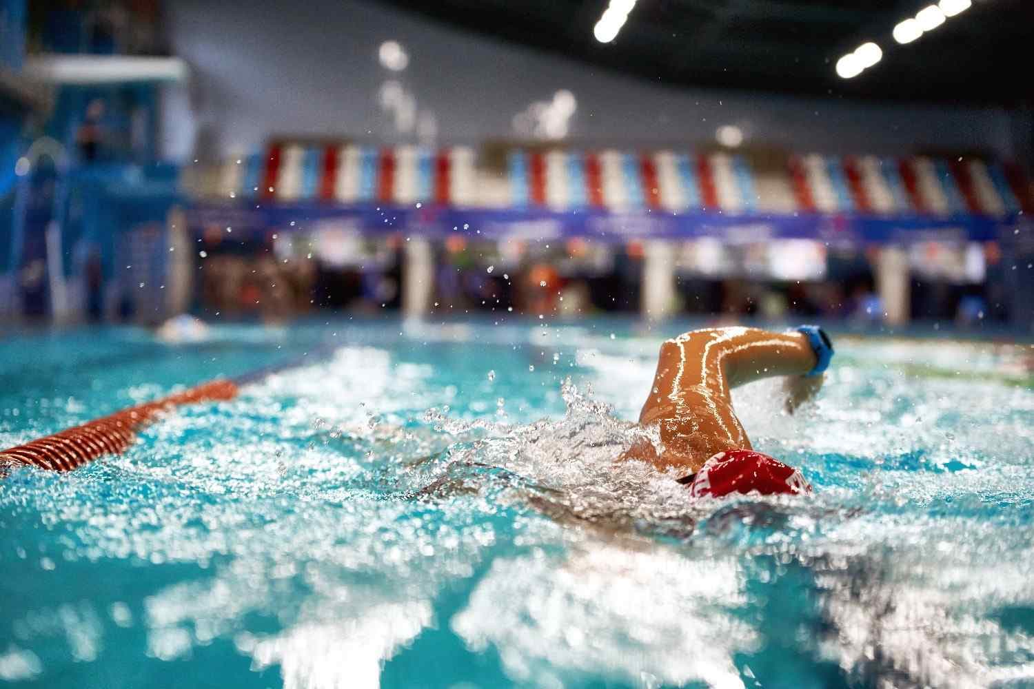 A swimmer diving into the pool