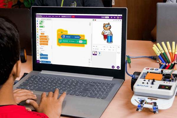 child creating a project in Scratch
